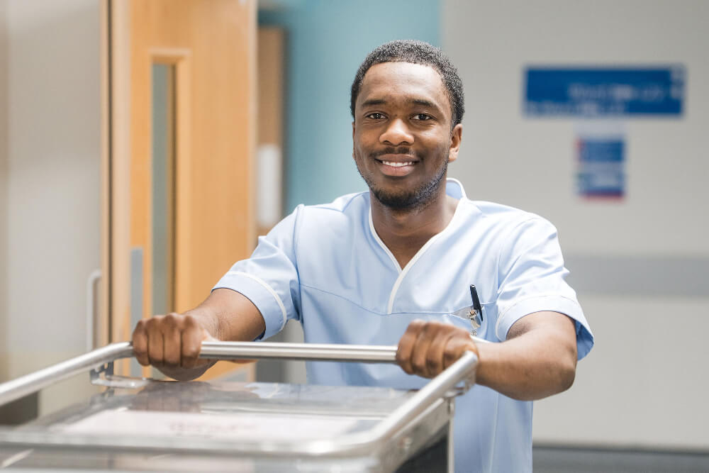 A technician pushing a trolley